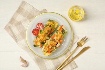 Flat lay composition with baked stuffed zucchinis served on white wooden table