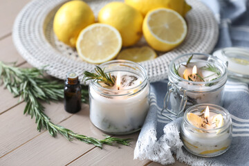 Natural homemade mosquito repellent candles and ingredients on wooden table