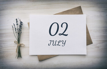 july 02. 02th day of the month, calendar date.White blank of paper with a brown envelope, dry bouquet of lavender flowers on a wooden background. Summer month, day of the year concept