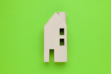 Eco-friendly home. Modern cottage on a green background. Investing in real estate.