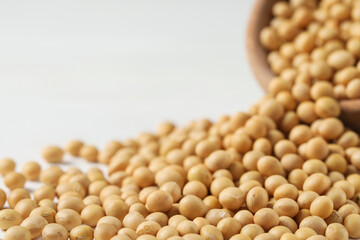 Heap of soy on white table, closeup. Space for text