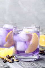 Organic blue Anchan with lemon on table, closeup. Herbal tea