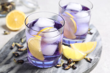 Organic blue Anchan with lemon on table. Herbal tea