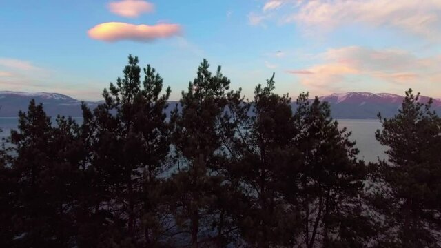 Freshwater mountains lake Sevan and beautiful sky heaven during sunset aerial drone fly over footage.