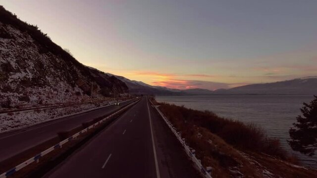 Freshwater mountains lake Sevan and beautiful sky heaven during sunset aerial drone fly over footage.