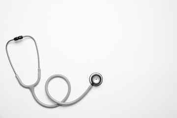 Stethoscope on white background, top view. Space for text