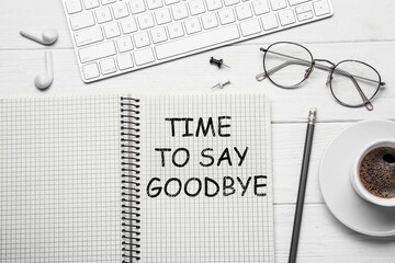 Notebook with text Time to say goodbye on white wooden table, flat lay