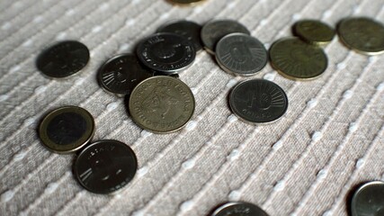 Coins fall  onto a texture  surface