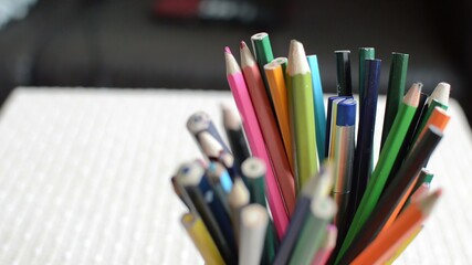  close-up  shot of colored pencils standing in a jar.