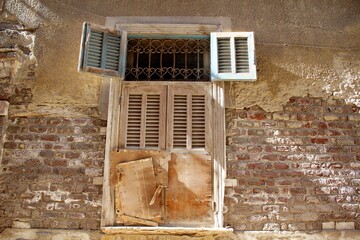 A semi open shutter of an old wooden window in Rashid in Egypt