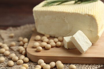 Pieces of delicious tofu and soy on table, closeup