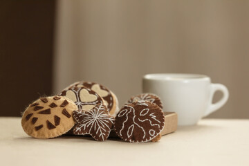 Handmade felt cookies with chocolate are on a beige background. The concept of a romantic gift for Valentine's Day, a greeting card for mothers. Felt game food, soft sweets for pretend food.