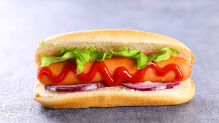 hot dog- sandwich with sausage and lettuce with sauce