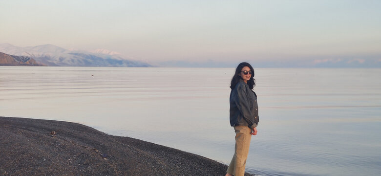 Young Caucasian female on the background of a beautiful lake Sevan in Armenia