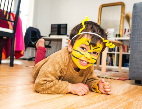 Little Boy With Bee Face Paint And Playing At Home