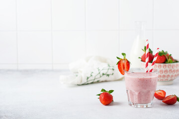 Strawberry smoothie or milkshake with berries and oatmeal in glass jar on gray or white concrete background. Vegetarian healthy drink. Close up. Selective focus.
