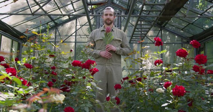 Hipster Man Gardener With Big Flower In Hands In Big Garden. Flowers Bussines. Spring Flowers. Aesthetic Shot