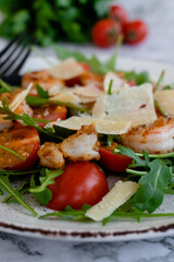 close up salad with arugula, shrimps and parmesan cheese
