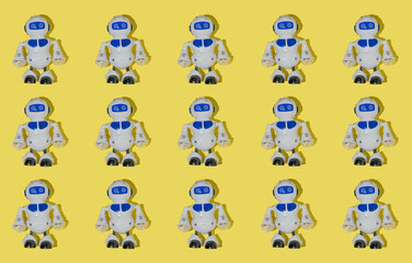 Fototapeta premium Creative pattern made with robot toy on bright yellow background. Retro style creative composition. Fun idea with childrens toys.