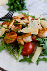 close up salad with arugula, shrimps and parmesan cheese