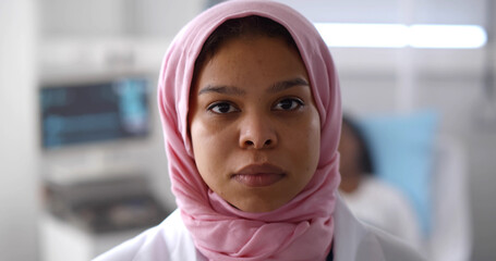 Close-up of muslim female doctor looking at camera working at hospital