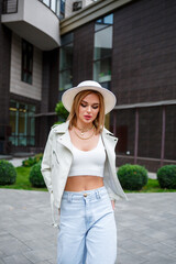 Close-up portrait of a beautiful young girl. Woman in stylish clothes. Businesswoman walking on the street