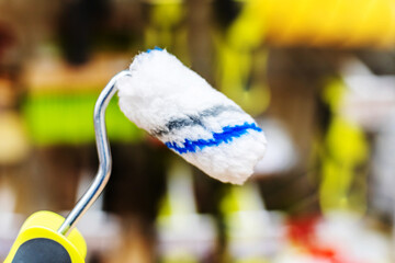 Small roller brush for painting. Choosing a tool for painting walls and ceilings in a store....