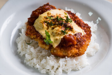 chicken parmigiana; deep fried chicken breast with tomato sauce and melted cheese on top