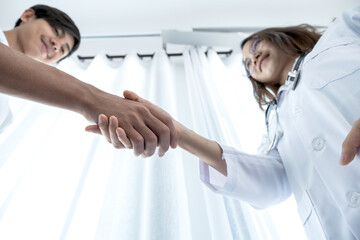 Fototapeta premium Hands of doctors and patients shaking after discuss the results of the health examination