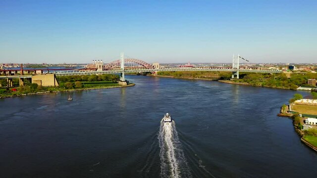 Aerial View of a Ferry Boat Approaching the RFK and Hell Gate Bridge