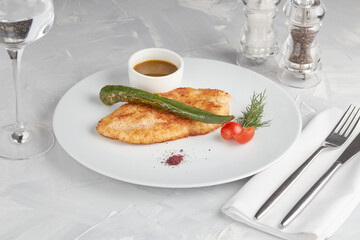 Pork schnitzel on a white plate