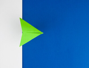 Travel concept with paper plane on white and blue paper background