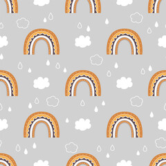 Cute childish seamless pattern with rainbow, clouds and rain in the sky.