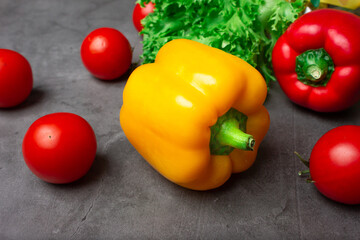 Red and yellow peppers. Fresh vegetables. Green salad. Tomatoes are red.