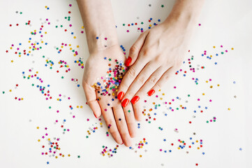 Naklejka na ściany i meble Manicured woman's nails with red nail polish.