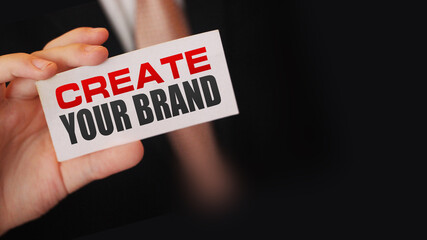 Create Your Brand message on card in businessan hand. Business startup concept