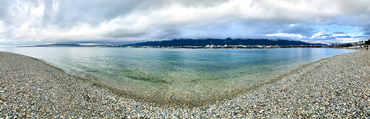 Panoramic view of the pebble beach on the sea
