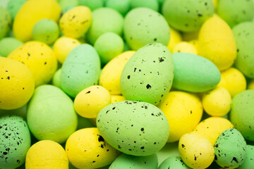 Yellow and green Easter eggs on the pile. Spring holidays concept