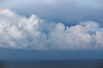 Naklejka premium Cumulus storm clouds over the sea, weather forecast, atmospheric front