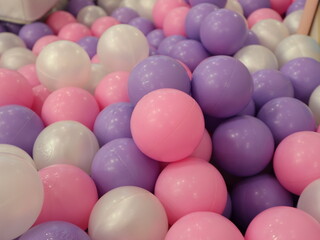 ball pit full of  pink plastic balls and purple balls design for children's joyful leisure time