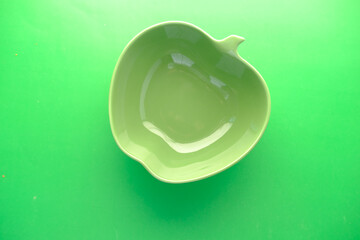 empty bowl on green background top down