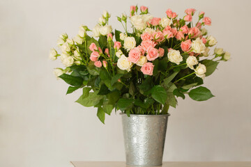 Bouquet of pink and cream roses in a vase on the table