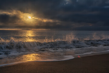 Dramatic sunrise on the beach in Burgas, Bulgaria. Sunrise on the Burgas Bridge. Bridge in Burgas - symbol of the city. 