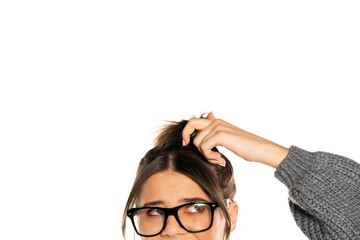 Half portrait of a young woman scratchung her hair