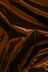 part of beautiful red gold leather fabric with folds