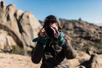 young woman taking photos in the nature