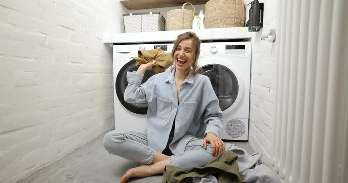 Housewife throwing clothes at the laundry