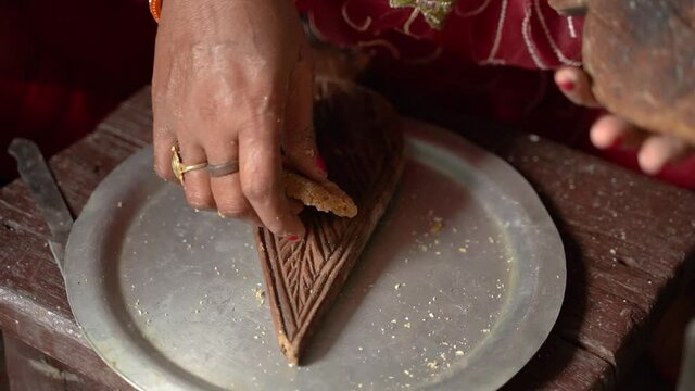 Woman making thekua by hand for chhath puja