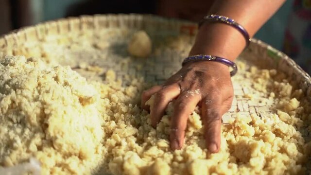 Woman making thekua by hand for chhath puja