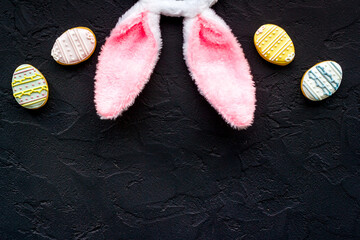 Obraz na płótnie Canvas Happy Easter. Bunny ears with colorful eggs cookie, top view